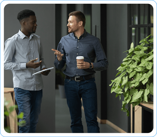 Two Professionals Walking and Discussing Salesforce Integration in a Modern Office Setting
