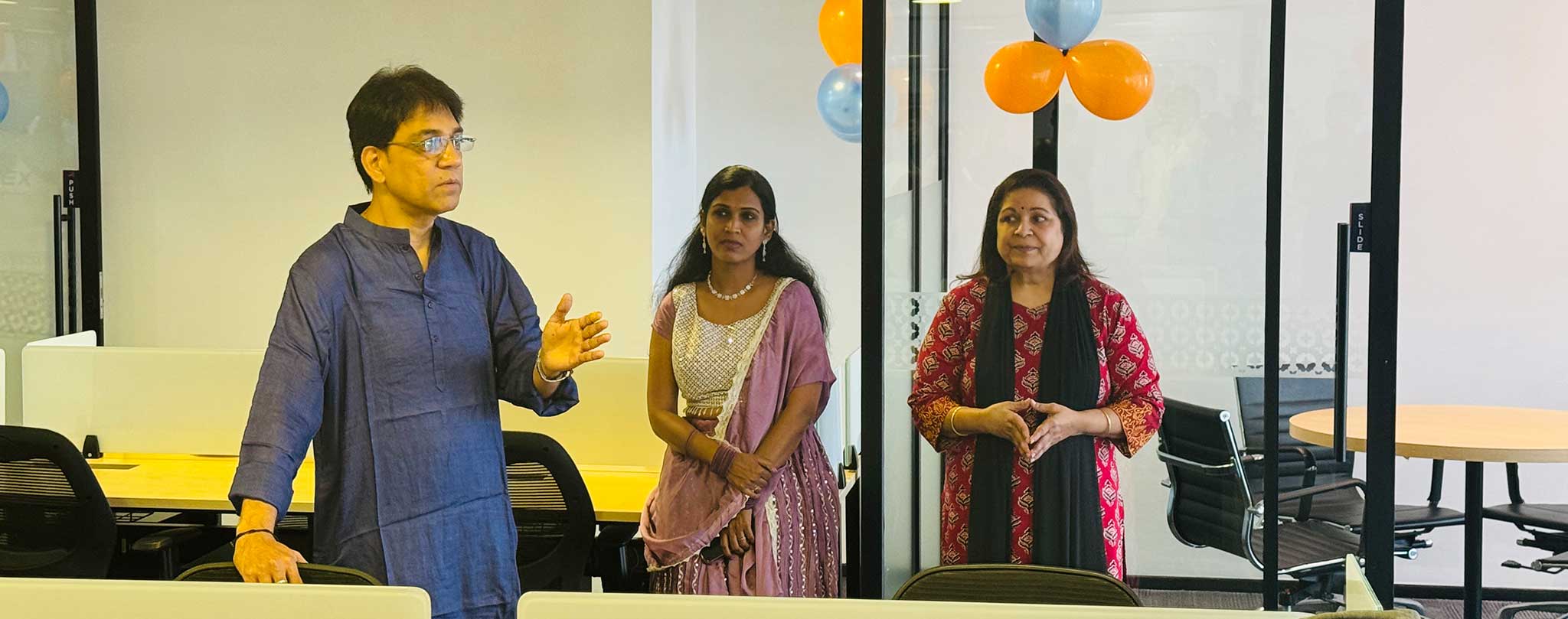 Leadership team members sharing inspiring words during the office inauguration event.